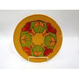 A Poole Delphis charger, yellow ground with ring design in green and red. Marks to base. 34.