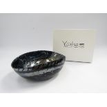 A Yalos Murano glass bowl with pinched sides, dark iridescent blue and silver.