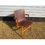 A Danish stained beech desk chair with brown leatherette covered seat,