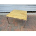 A Durlston square coffee table with ply top on chromed metal base,