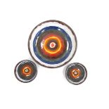 Three circular mid Century ceramic wall hangings with abstract design, one large and one small,