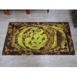 A green and brown wool woven rug,