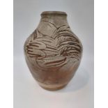 A studio pottery vase with wax resist design of a hen with nest of eggs.