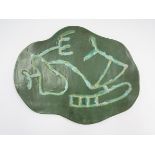 A 1950's French studio pottery green glazed plaque with abstract design. Signed verso.