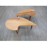 A pair of 1950's walnut occasional tables with palette shaped tops, raised on tapering legs. 80.