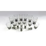 Three sets of six Holmegaard drinking glasses in smoked glass.