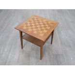 A walnut and satin wood games table with undertier, raised on square tapering legs. 49.5cm x 49.