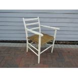 A 1940's Danish armchair, white painted frame with horizontal bar back,