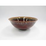 A Danish pottery bowl by Carl Harry Stalhane, brown treacle glazes, incised marks to base.