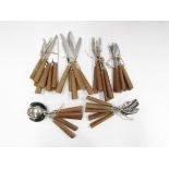 A collection of Mills Moore stainless steel and teak cutlery,