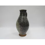 A Studio pottery ewer in stoneware with salt glazed. Indistinctly signed to base. 32.