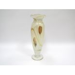 An Okra Glass tall iridescent glass vase in white, ochre and gold colours, clear foot.