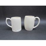 Two white glazed ceramic mugs designed by Keith Murray for Wedgwood,