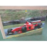 An Eddie Irvine poster 68cm x 98cm and 16 Ferrari F310B posters 68cm x 98cm