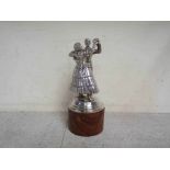 A chromed mascot of ballroom dancers mounted on plinth