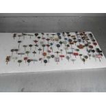 A board containing a quantity of cap pins including Mobil, Esso, Avia,