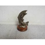 A brass leaping Salmon mascot on plinth