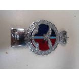 A chrome and enamel badge 'PER ARDUA AD ASTRA' by J.R.