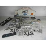 A box of mixed car badges etc