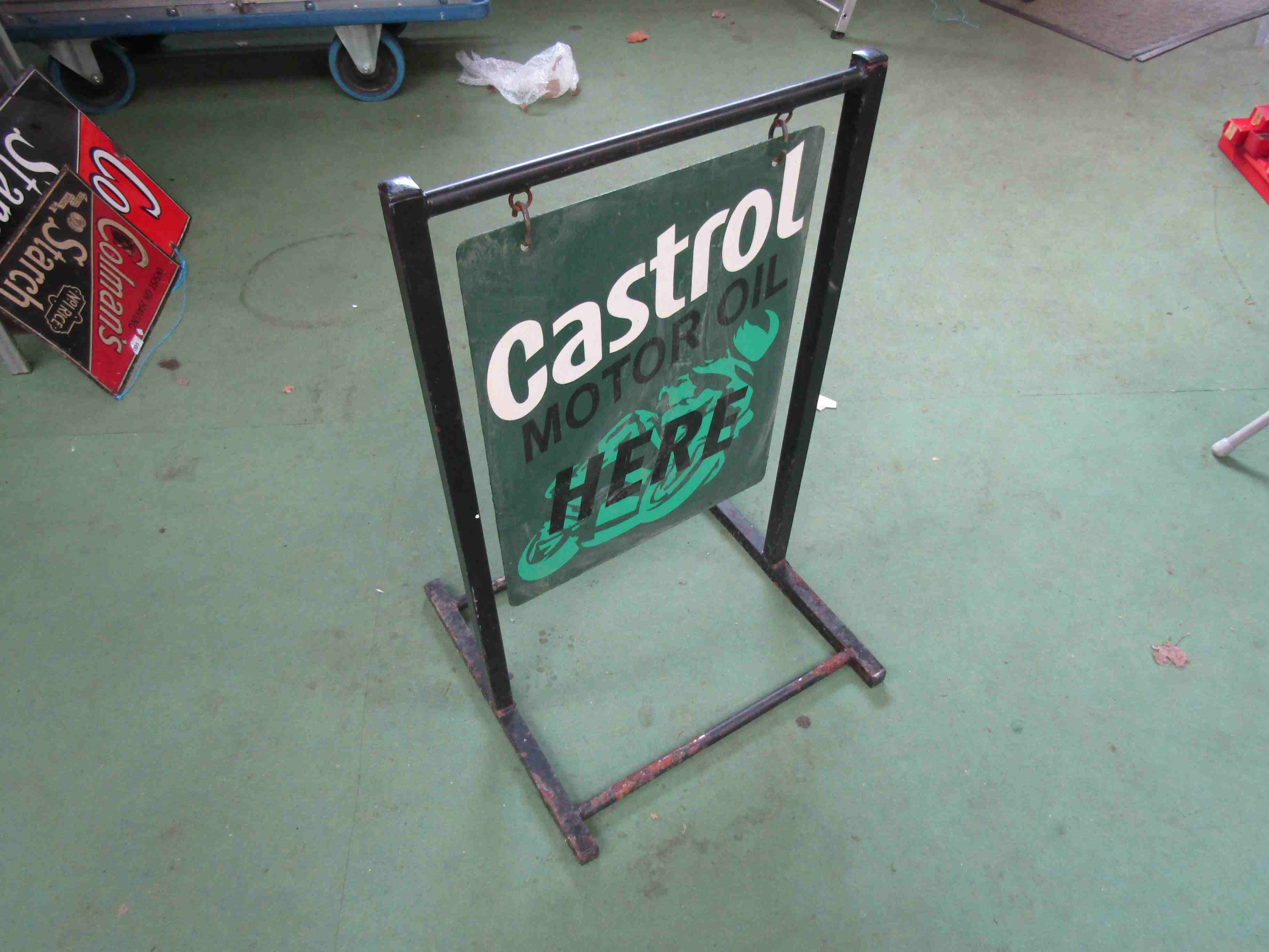 A double sided hand painted Castrol swing sign with stand,