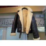 A sheepskin flying jacket in superb condition size XL with a pair of brown leather gauntlets