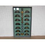 A framed 'AA' lapel badge display