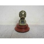 A brass Puppy mascot on a turned plinth signed Desmond to base