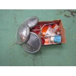 A box of chromed hub caps and a box of light lenses