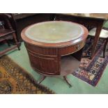 A reproduction drum table with insert tooled leather top,