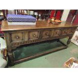An oak six drawer sideboard by Titchmarsh & Goodwin, carved supports over stretcher base,