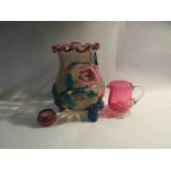 An Art Nouveau style glass vase with floral detail along with two pieces of cranberry glass