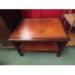 A Bevan and Funnel Georgian style mahogany two tier lamp table with gilt tooled leather shelves,