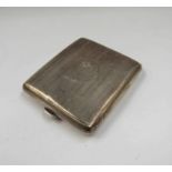 A silver cased travel clock in form of a cigarette case,