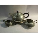 A pewter teapot with stand,