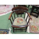 An oak Victorian child's captains chair with spindle decoration and needlepoint seat on turned legs