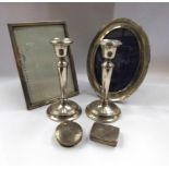 A pair of silver candlesticks,