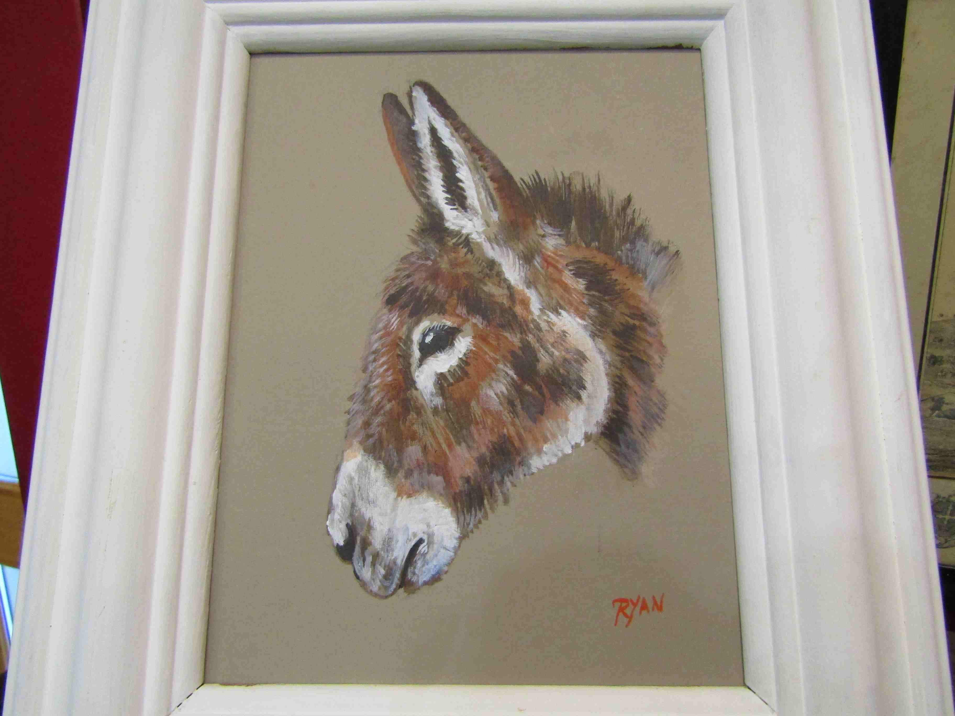 RYAN: Oil on board depicting a donkey, in white painted frame,