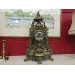 A highly decorative cast brass mid-20th Century striking clock,