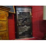 A Circa 1900 mahogany glazed corner cabinet with astragal glazing and blind fret carved top,