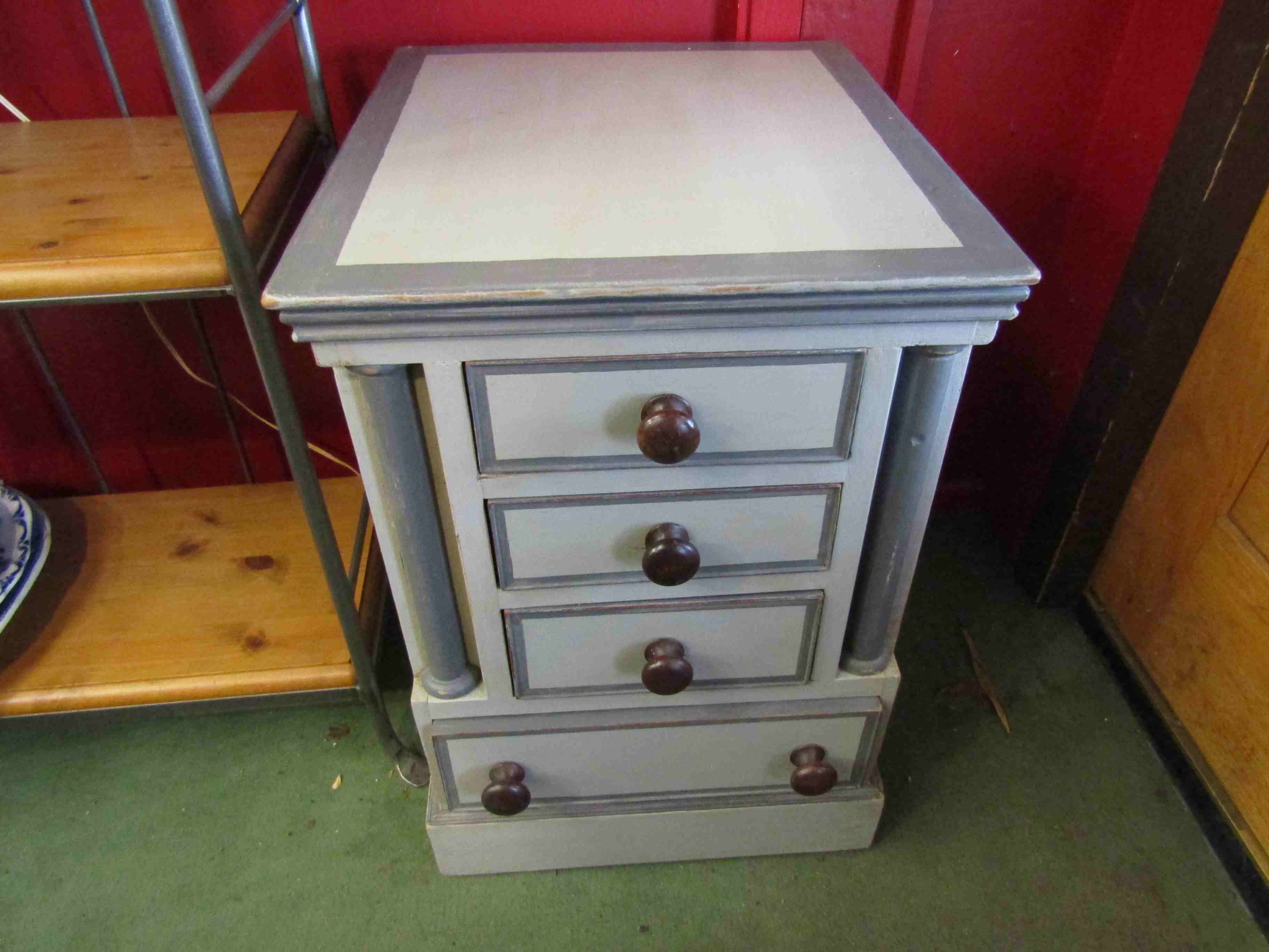 A painted four drawer bed side chest,