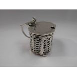 A silver mustard pot with glass liner,