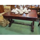 A William IV rosewood library table the two frieze drawers over a lyre end base joined by a turned