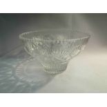 A crystal glass bowl with tapering sides,