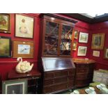 An astragal glazed mahogany cabinet on bureau base, two short over two long drawers.