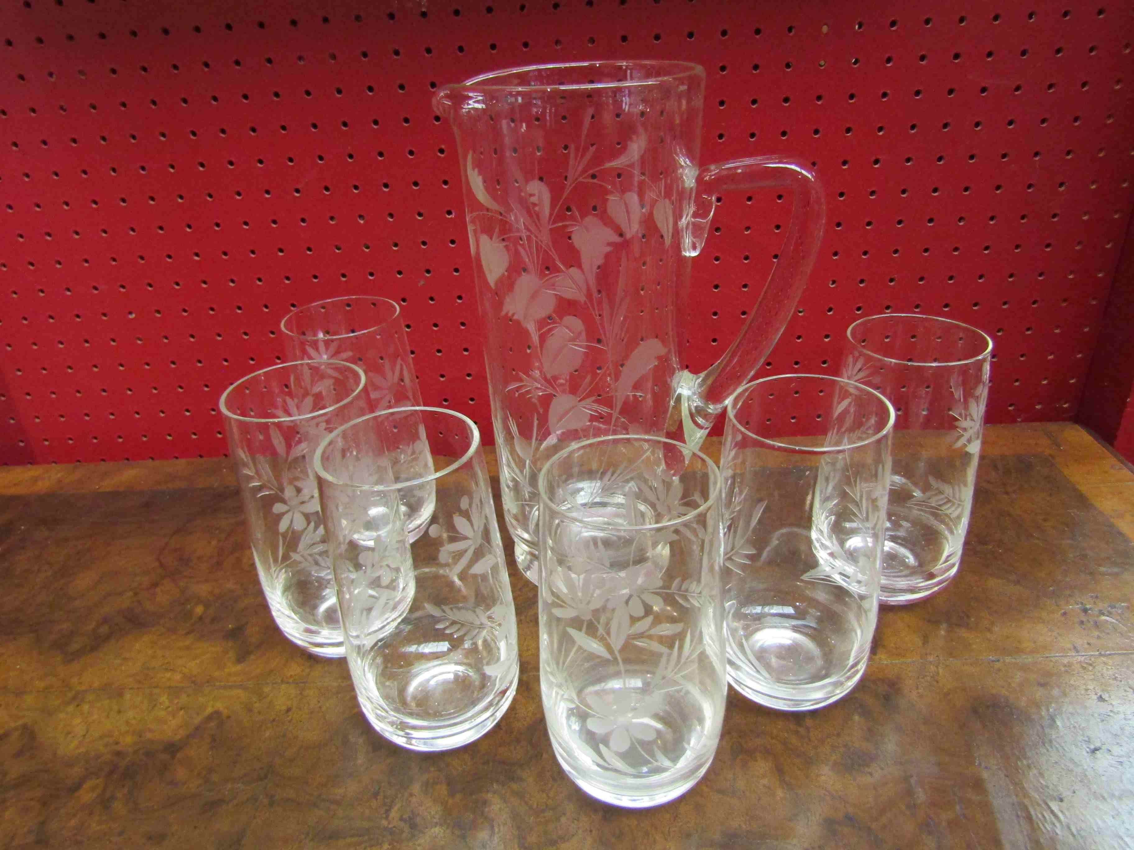 A lemonade jug and six glasses with etched floral detail