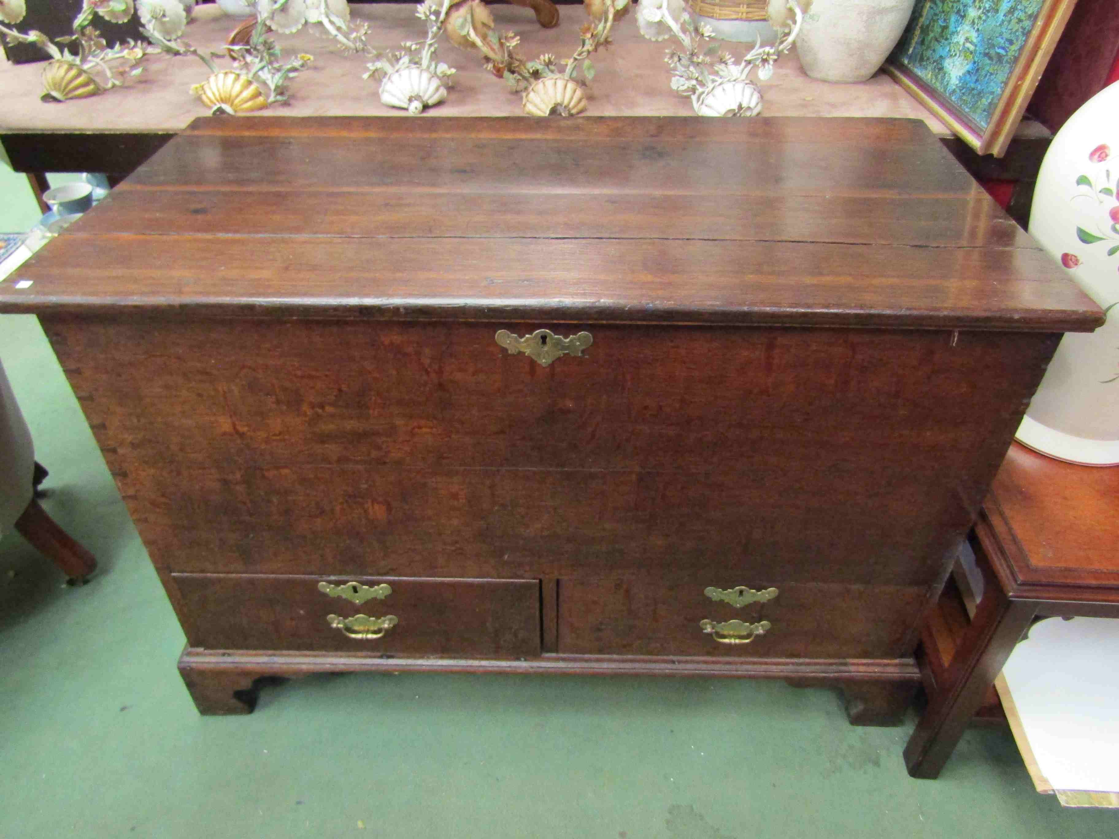 A late Georgian oak mule chest with two drawers on bracket feet,