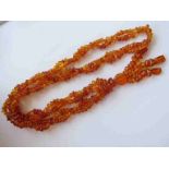 A double strand amber tassel bead necklace, 72cm long, 43.