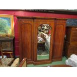 An Edwardian mahogany triple wardrobe with mirrored central door, 207cm tall, 210cm wide,