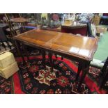 A reproduction mahogany nest of three tables