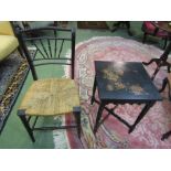 An ebonised side table with painted floral design top on cross stretcher base and an ebonised chair
